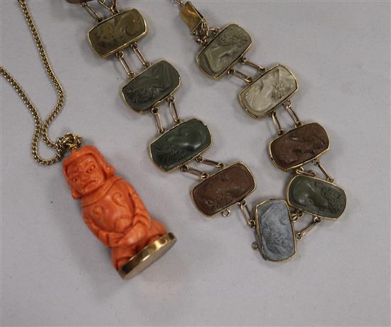 A yellow metal mounted cameo lava bracelet and a carved coral pendant on a chain.